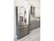 Modern kitchen showcasing a stainless steel refrigerator with water dispenser, gray cabinets, and tile backsplash at 18721 Seaview St, Orlando, FL 32833