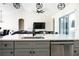 Bright kitchen featuring an island with gray cabinets, stainless steel appliances, and an open layout into the living room at 18721 Seaview St, Orlando, FL 32833