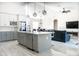 Open-concept kitchen flows into the living room, featuring stainless steel appliances, a central island, and modern finishes at 18721 Seaview St, Orlando, FL 32833