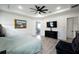 Comfortable main bedroom featuring a ceiling fan, luxury vinyl plank flooring, and modern decor at 18721 Seaview St, Orlando, FL 32833