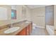Bright bathroom featuring double sink vanity with granite counters and tiled shower at 2311 Whitley Ln, Winter Haven, FL 33881
