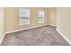 Bedroom with neutral walls, carpet, and two windows providing natural light at 2311 Whitley Ln, Winter Haven, FL 33881