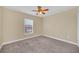 Bedroom featuring neutral walls, carpet, a ceiling fan, and a window at 2311 Whitley Ln, Winter Haven, FL 33881
