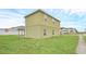 View of a two-story home's exterior with a covered patio and a well-maintained lawn at 2311 Whitley Ln, Winter Haven, FL 33881