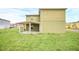 Two-story home's exterior showing the covered back patio and grassy lawn at 2311 Whitley Ln, Winter Haven, FL 33881