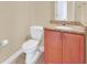 Cozy half bathroom featuring a granite counter top and vanity cabinet at 2311 Whitley Ln, Winter Haven, FL 33881