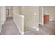 Hallway with neutral walls and carpeted floor leading to bathroom and bedroom at 2311 Whitley Ln, Winter Haven, FL 33881