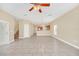 Open concept living area with tile floors and view of the kitchen and stairs at 2311 Whitley Ln, Winter Haven, FL 33881
