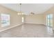Open living room with tile flooring, ceiling fan and natural light at 2311 Whitley Ln, Winter Haven, FL 33881