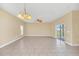 Bright living room features neutral walls, tiled floors, and ceiling fans at 2311 Whitley Ln, Winter Haven, FL 33881