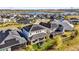 A backyard with lawn and trampoline, and solar panels on roofs in a neighborhood by a lake at 3029 High Pointe St, Clermont, FL 34711