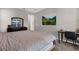 Neutral bedroom featuring a dresser and mirror along with a picture hanging on the wall at 3029 High Pointe St, Clermont, FL 34711