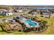 Resort-style pool and playground surrounded by mature landscaping and winding walkways at 3029 High Pointe St, Clermont, FL 34711