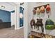 Entryway with hooks and storage for backpacks, hats, and shoes, leading into a living space at 3029 High Pointe St, Clermont, FL 34711