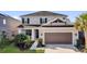 Charming two-story home featuring an attached two-car garage and well-manicured landscaping at 3029 High Pointe St, Clermont, FL 34711