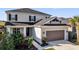 Charming two-story home featuring an attached two-car garage with beautiful landscaping at 3029 High Pointe St, Clermont, FL 34711