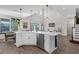 Modern kitchen featuring a large island with seating and views of the living area at 3029 High Pointe St, Clermont, FL 34711