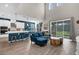 Open-concept living room with high ceilings and views of the kitchen and backyard at 3029 High Pointe St, Clermont, FL 34711