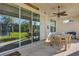 Outdoor dining on covered patio with ceiling fan and sliding glass doors at 3029 High Pointe St, Clermont, FL 34711