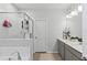 Clean and modern bathroom features dual sinks, a soaking tub, and a glass-enclosed shower at 3173 Riverboat Way, Oviedo, FL 32765