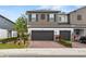 Modern home showcases a two-car garage, neutral exterior, and is enhanced by a brick driveway and tidy landscaping at 3173 Riverboat Way, Oviedo, FL 32765