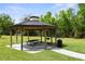 Community gazebo featuring a picnic table and grill, perfect for outdoor gatherings and relaxing in a park-like setting at 3173 Riverboat Way, Oviedo, FL 32765
