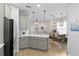 Bright kitchen features a large island with pendant lighting, open to the dining and living areas at 3173 Riverboat Way, Oviedo, FL 32765