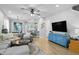 Open-concept living room featuring a sectional sofa, pendant lights, and a view to the kitchen at 3173 Riverboat Way, Oviedo, FL 32765