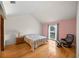 Cozy bedroom with hardwood floors, a vaulted ceiling, and soft natural light from the window at 320 Isabella Dr, Longwood, FL 32750