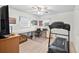 Bedroom with ceiling fan, desk, shelves, and workout equipment at 320 Isabella Dr, Longwood, FL 32750