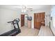 Bedroom with ceiling fan, desk, shelves, and workout equipment at 320 Isabella Dr, Longwood, FL 32750