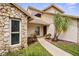 Charming home entrance with stone accents, complemented by lush landscaping and a welcoming pathway at 320 Isabella Dr, Longwood, FL 32750