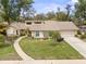 Charming single-story home boasting a stone facade, manicured lawn, and a curved walkway to the front door at 320 Isabella Dr, Longwood, FL 32750