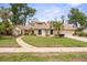 Inviting single-story residence featuring a stone accent, a well-kept lawn, and a curved pathway leading to the entrance at 320 Isabella Dr, Longwood, FL 32750
