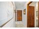 Hallway with tile flooring, wooden doors, and artwork on the walls at 320 Isabella Dr, Longwood, FL 32750