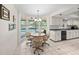 Bright eat-in kitchen boasts white cabinets, tile floors, and pool view from the window at 320 Isabella Dr, Longwood, FL 32750