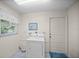 Laundry room featuring a white door to the exterior, and front-loading dryer at 320 Isabella Dr, Longwood, FL 32750