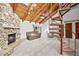 A cozy living room features a wood ceiling, a stone fireplace, a spiral staircase, and sliding glass doors at 320 Isabella Dr, Longwood, FL 32750