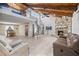 Spacious living room featuring vaulted wood ceilings, stone fireplace, and spiral staircase to upper level at 320 Isabella Dr, Longwood, FL 32750