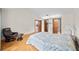 Spacious bedroom with hardwood floors, a vaulted ceiling, and a glimpse into other rooms through open doorways at 320 Isabella Dr, Longwood, FL 32750