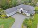 Aerial view of the grey single-Gathering home featuring manicured landscaping and a paver driveway at 3340 Fernlake Pl, Longwood, FL 32779