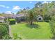 Expansive backyard features lush green lawn, mature trees, and screened-in lanai, perfect for outdoor enjoyment at 3340 Fernlake Pl, Longwood, FL 32779