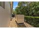 Exterior shot showing the house generator and pebble landscaping against a lush green backdrop at 3340 Fernlake Pl, Longwood, FL 32779