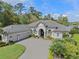 Stately home featuring a large driveway, meticulous landscaping, and a beautiful front facade at 3340 Fernlake Pl, Longwood, FL 32779