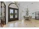 Open-concept foyer with decorative front door, tile flooring, and view of the formal dining room with chandelier at 3340 Fernlake Pl, Longwood, FL 32779