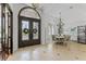 Stunning foyer featuring tile floors, a decorative front door, and an adjacent dining area with shuttered windows at 3340 Fernlake Pl, Longwood, FL 32779