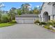 Spacious three-car garage featuring an extended paver driveway and manicured landscaping at 3340 Fernlake Pl, Longwood, FL 32779