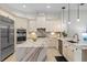 Bright kitchen featuring custom cabinets, marble countertops, and stainless steel appliances at 3340 Fernlake Pl, Longwood, FL 32779