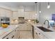 Bright kitchen featuring custom cabinets, marble countertops, and stainless steel appliances at 3340 Fernlake Pl, Longwood, FL 32779