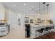 Kitchen with marble countertops, custom cabinets, bar stool seating, and stainless appliances at 3340 Fernlake Pl, Longwood, FL 32779